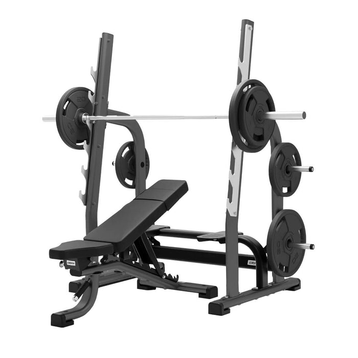 Multi adjustable weight bench in grey shown with barbell and weight plates on the rack